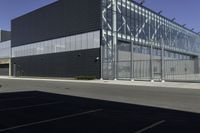 there is an outside building with black facade and glass walls and doors for cars and people to look at