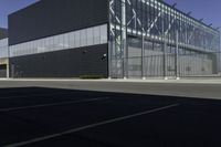 there is an outside building with black facade and glass walls and doors for cars and people to look at