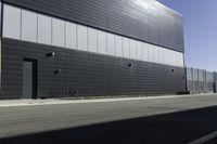 a very large building with a sign on the side of it's sides along an empty street