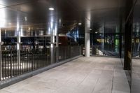 an empty office hallway with several windows and a metal railing with no doors on it