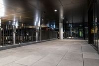 an empty office hallway with several windows and a metal railing with no doors on it