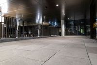 an empty office hallway with several windows and a metal railing with no doors on it