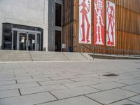 a group of people riding skateboards near wooden panels and stairss with artwork on them