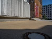 a group of people riding skateboards near wooden panels and stairss with artwork on them