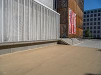 a group of people riding skateboards near wooden panels and stairss with artwork on them