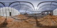 a small pond sitting in a construction site with several structures that are on the ground