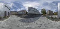 an image of buildings in a small city seen through a 360 - view lens taken by the same person