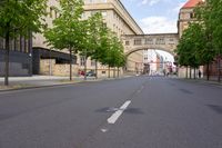 the road is empty, and there is no traffic around the street in the foreground