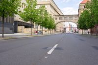 the road is empty, and there is no traffic around the street in the foreground