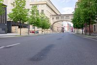 the road is empty, and there is no traffic around the street in the foreground