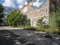 a large building in the middle of a lot covered in graffiti and trashing graffiti