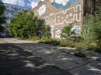 a large building in the middle of a lot covered in graffiti and trashing graffiti