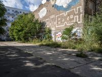 a large building in the middle of a lot covered in graffiti and trashing graffiti