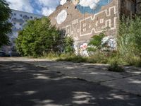 a large building in the middle of a lot covered in graffiti and trashing graffiti