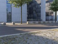 two motorcycles that are standing outside of an office building in the city or near a road