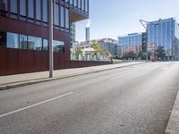 an empty city street with buildings and a truck on the side of it next to rocks