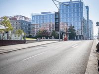 an empty city street with buildings and a truck on the side of it next to rocks
