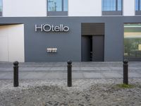 a hotel entrance with the wordshotello on it in a sign language on a wall