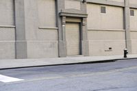 a parking meter on the corner of a street with a building behind it and a fire hydrant next to it