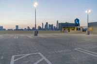 empty parking lot with city skyline in the background at sunset or dusk in large city