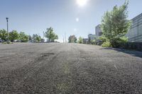 the sun shines brightly through the clear sky over a parking lot with cars and trees