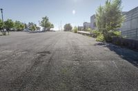 the sun shines brightly through the clear sky over a parking lot with cars and trees