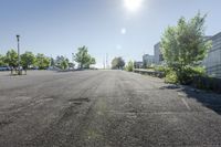 the sun shines brightly through the clear sky over a parking lot with cars and trees