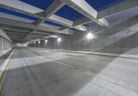 an empty parking garage with no people in it at night time time with only one stop sign
