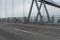 a photo of a highway with a building in the background and a man riding a bicycle