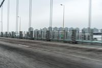 a photo of a highway with a building in the background and a man riding a bicycle