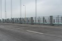 a photo of a highway with a building in the background and a man riding a bicycle