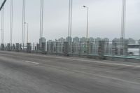 a photo of a highway with a building in the background and a man riding a bicycle