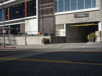 there is an outside view of the city building with a traffic light on the curb