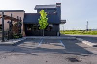 an empty restaurant in the parking lot outside of a building with awning and awnings