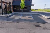 an empty restaurant in the parking lot outside of a building with awning and awnings