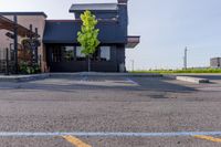 an empty restaurant in the parking lot outside of a building with awning and awnings