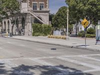 a building next to an intersection with street signs near it in the city of los angeles