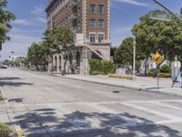 a building next to an intersection with street signs near it in the city of los angeles