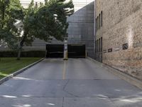 a parking garage has yellow lines going from the driveway into the building on the left side