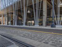 this is a train tracks and a bus station in an urban setting at dusk with the building visible