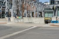 an intersection with a building in the background and a sign for an entrance is on display at the corner