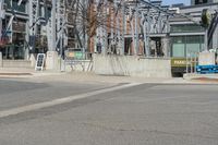 an intersection with a building in the background and a sign for an entrance is on display at the corner