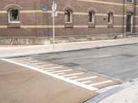 stop signs are shown at an intersection next to a building on the side of an old brick road