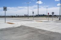 a view of an intersection with the sky in the background and the signs to both sides of the street