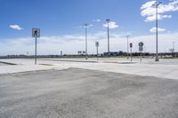 a view of an intersection with the sky in the background and the signs to both sides of the street