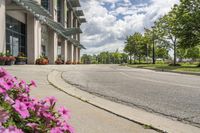 view of a road in the middle of an intersection, with flowers in front of it