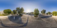 a distorted mirror photo of a skateboard park and parking lot in the city of a city