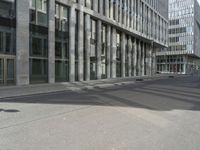 a white skateboarder sitting on his board outside of an office building in the city