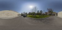 two circular mirrors that show buildings near each other, and a street light in the background