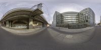 a fish eye view of an industrial area with modern buildings and a public sidewalk through the lens